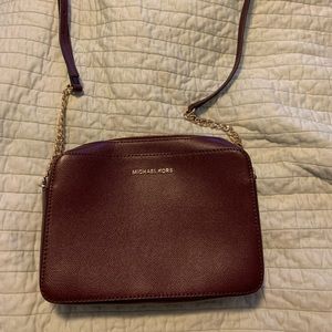 Plum Michael Kors purse with strap